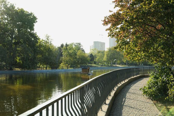 Beautiful city park with lake in sunny morning