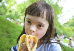 Close up of young female eating a banana