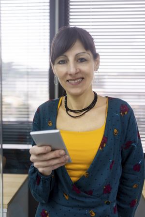Businesswoman using smartphone at office