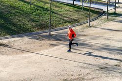 Male jogging through track in the park