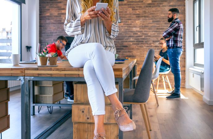 Unrecognizable businesswoman looking mobile in the office