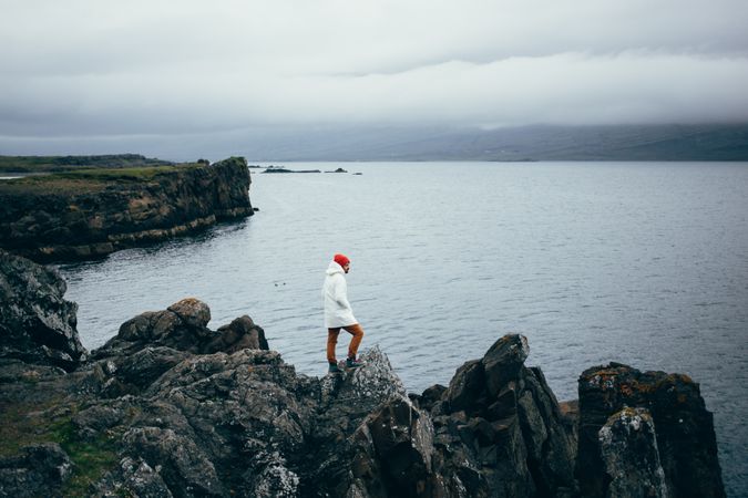 Man on jagged cliff rocks, landscape