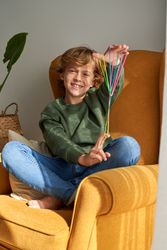 Positive boy during string game at home