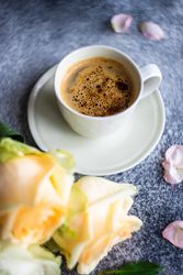 Yellow flowers with cup of coffee