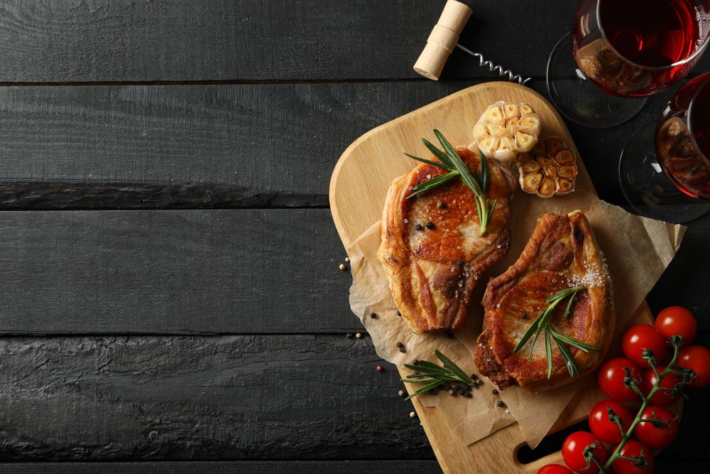 Composition with fried steaks and wine. Grilled food