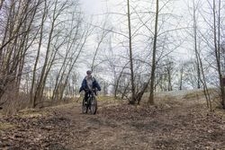 Woman riding a bicycle down a hill