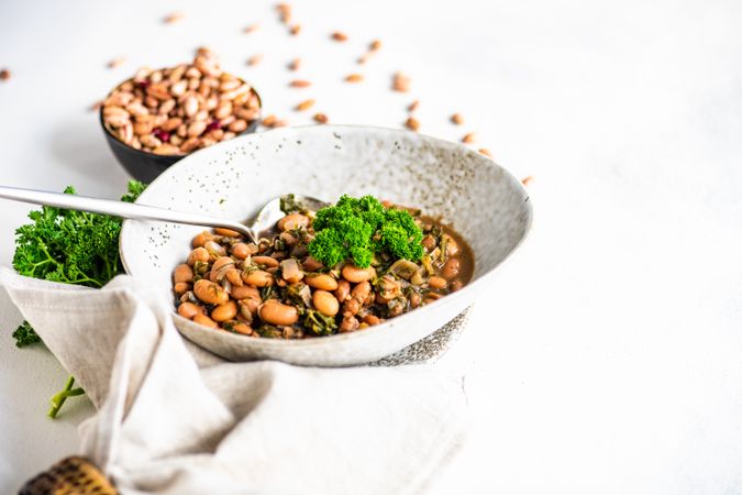 Traditional Georgian bean dish - lobio, served in modern textured ceramic bowl with napkin