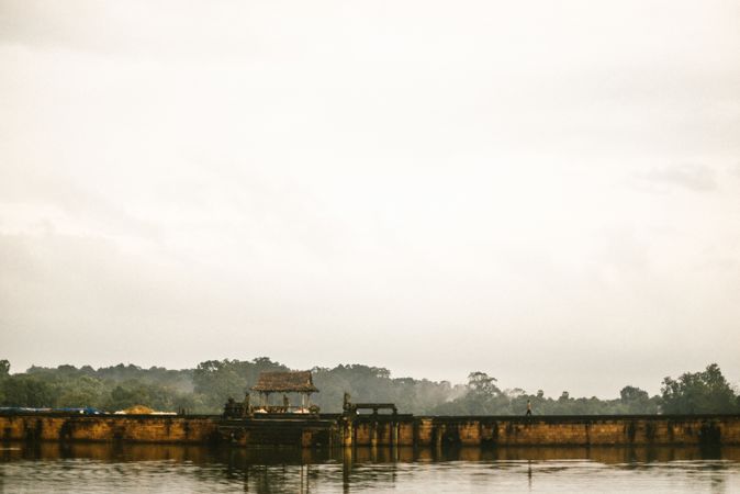 People on bridge between water and forest