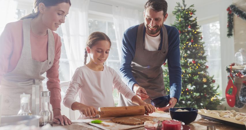 Family Celebrating the Holidays: Parents and Child Baking Together During Christmas.