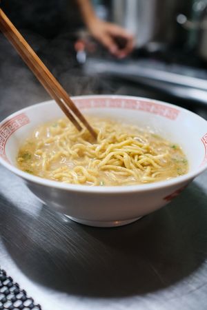 Delicious noodle soup with chopsticks