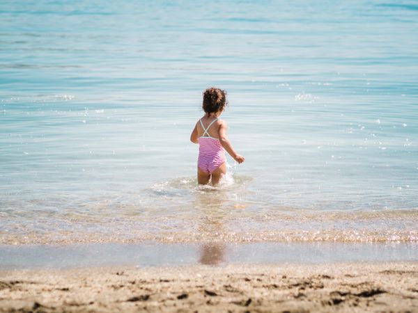 Cheerful girl having fun in warm sea