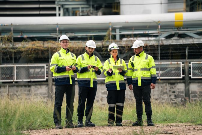Group of engineer workers checking project at refinery oil factory