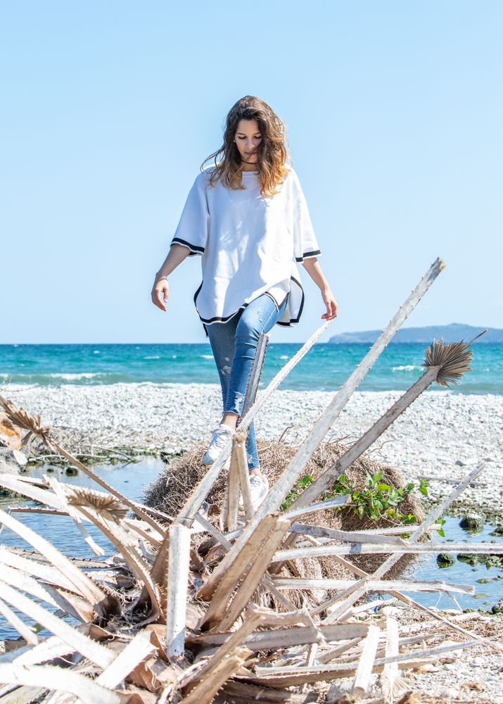 Young woman walking near dried plants