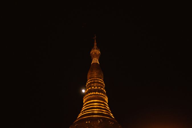 Wonderful high tower with illuminated lamps at night