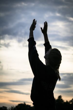 Woman meditating during sunset in nature