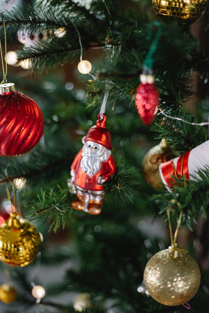 Red and gold Christmas baubles on tree in close-up