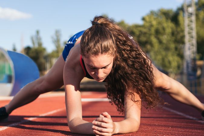 A female athlete warming up before running.