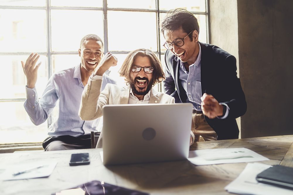 Cheerful excited businessmen celebrating their success