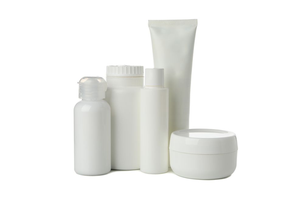 Blank bottles for cosmetics isolated on light background