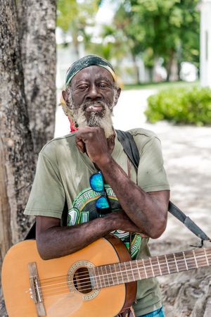 Jamaican man playing guitar