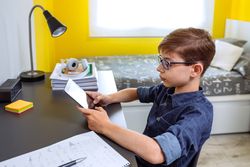 Boy doing homework with a tablet