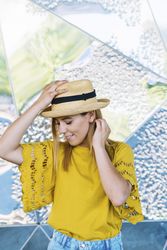 Stylish woman posing in straw hat