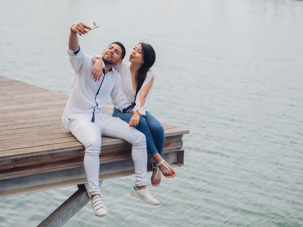 Woman with man taking photo selfie