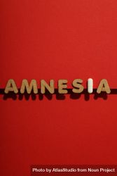 Cork letters of the word “Amnesia” with pill, in center of vertical composition 42ZRq4