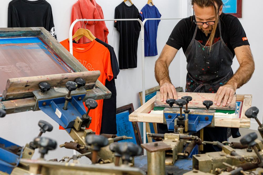 Artist printing screen in workshop
