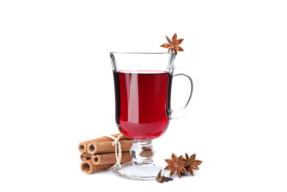 Glass of tasty mulled wine isolated on studio background