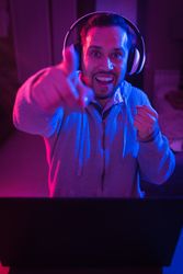 Man listening cheerfully to music with headphones.