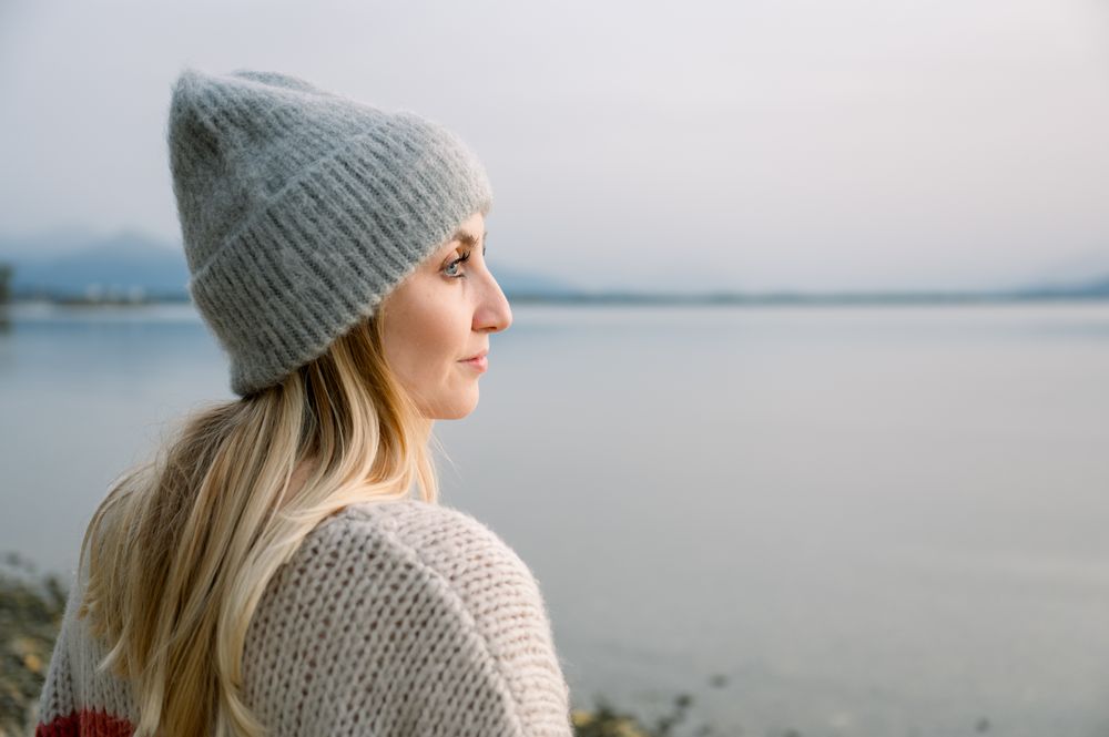Side view of woman looking away against lake