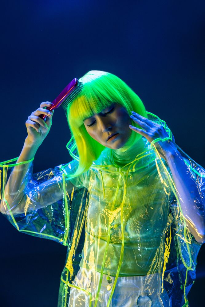 Asian woman brushing yellow hair