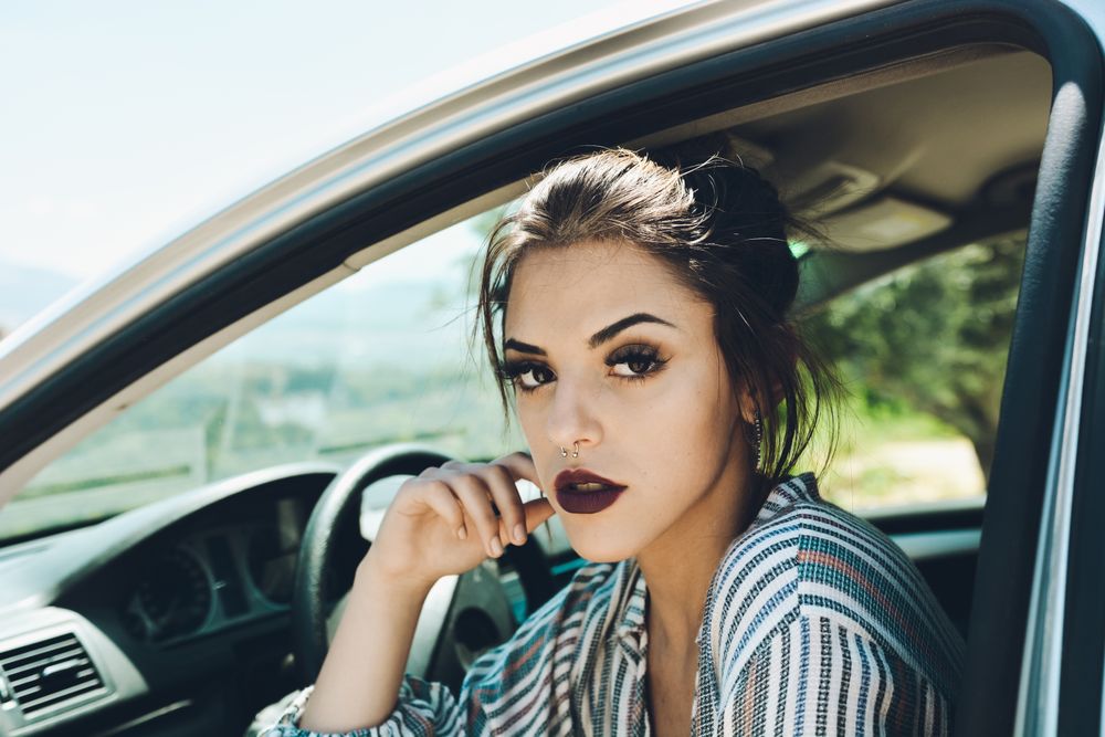 Portrait of woman sitting in the car's.