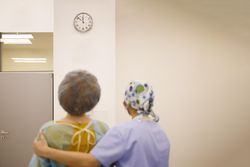 Rear view of patient just out of surgery with doctor