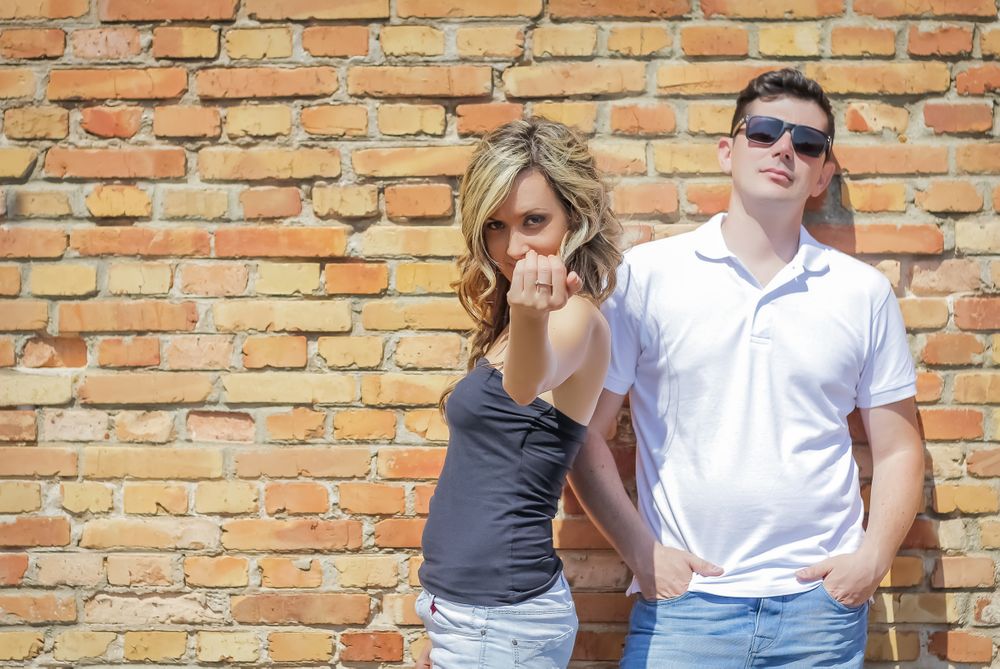 Couple portrait in front of brick wall