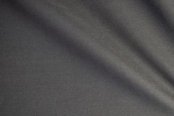 Wavy dark grey fabric background texture. shiny, glossy and elegant background.