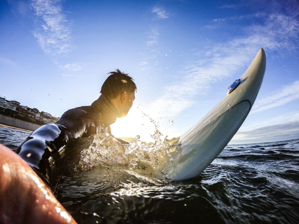 Man riding surfboard during daytime