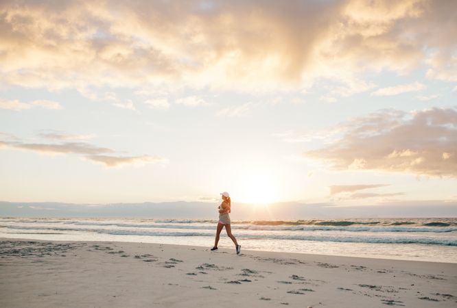Healthy female jogging on the sea shore