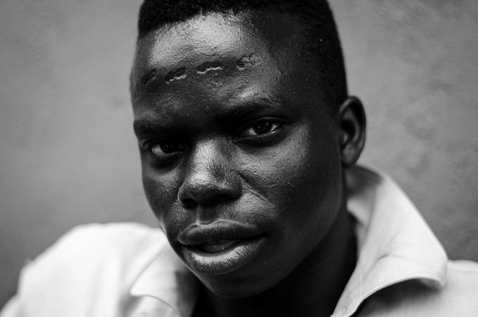 Grayscale portrait of young man in collared shirt
