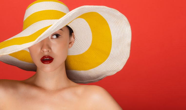 Beauty shot of young woman wearing floppy hat