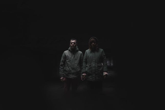Portrait of a couple. Standing strong in the darkness concept.
