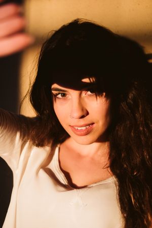 Smiling woman in spot of light