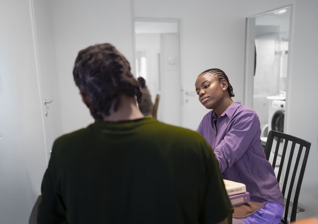 Casual Study Session at Home with Books and Conversation.