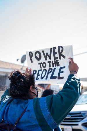 Los Angeles, CA, USA — June 7th, 2020: woman holding “Power to the people” sign at protest