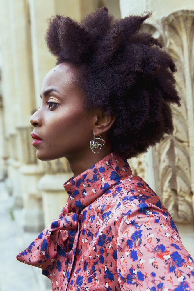 Side view of woman in pink and blue shirt