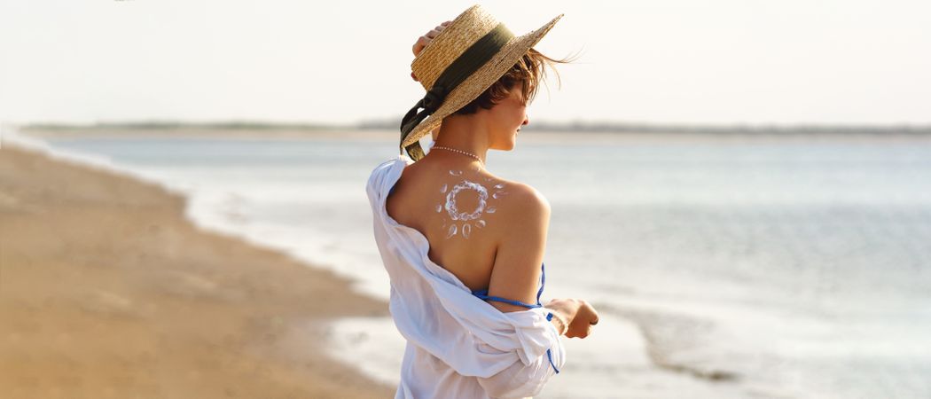 Woman with Sunscreen in sun shape