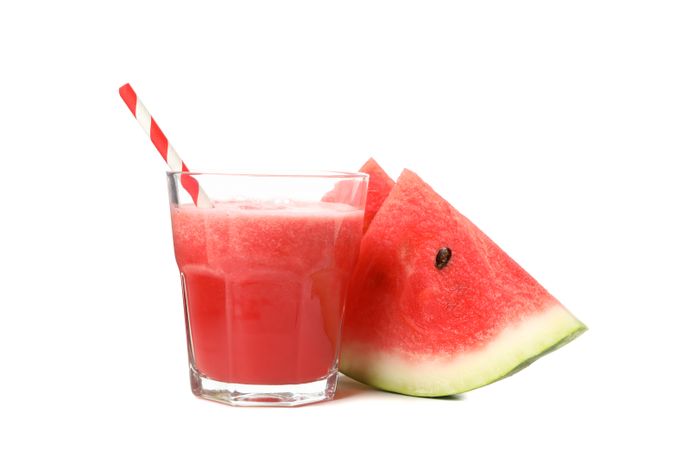 Glass of watermelon juice and slices isolated on blank background