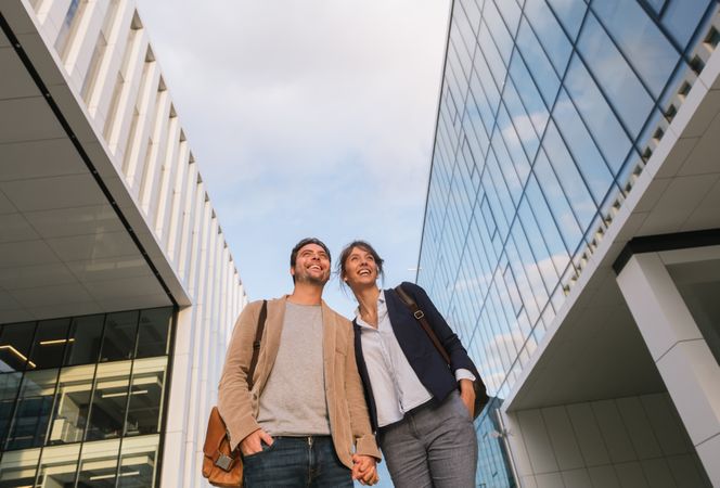Businesspeople couple outside contemporary building