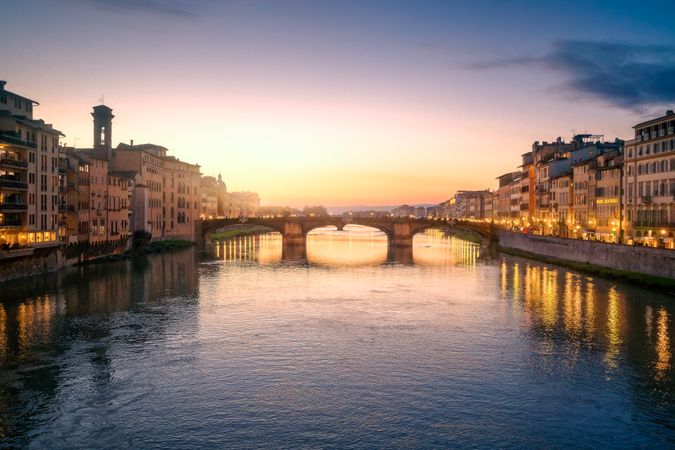 Old bridge across channel in sunset